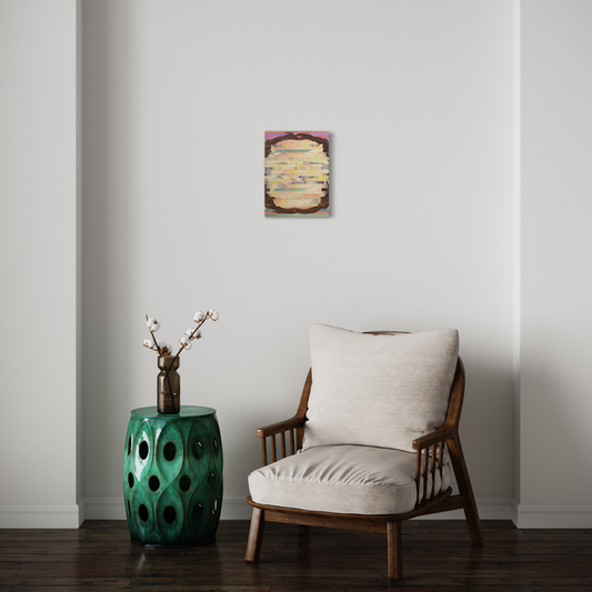 The artwork 'Faceless 2' by Patricia Fabricant features abstract layers of cream and yellow tones with burgundy edges, displayed above a mid-century modern chair and emerald ceramic garden stool. Gouache on paper mounted on panel, the 16x12 inch piece creates a minimalist focal point against a white wall, complementing the room's modern decor.