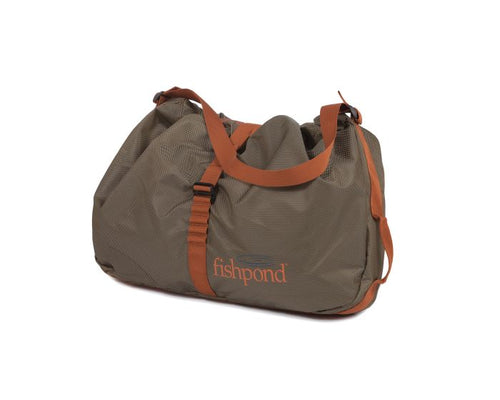 Fishpond Burrito Wader Bag with durable material and straps, designed for storing wet waders and boots after fly fishing trips