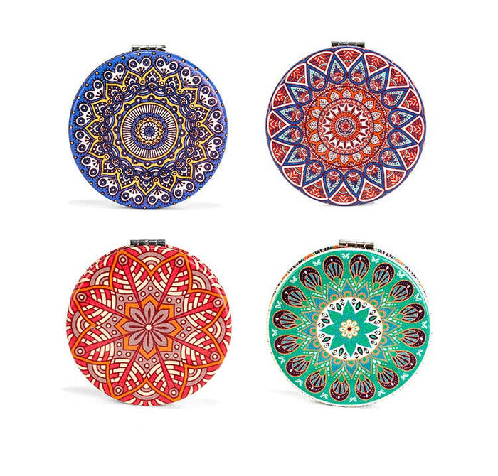 Four round decorative plates with colorful mandala patterns on a white background